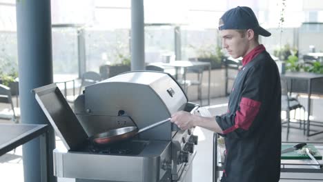 chef preparing food outdoors on a grill