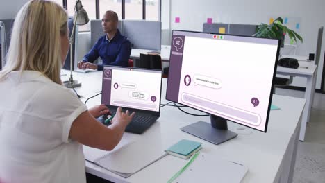 Caucasian-woman-in-office-using-computers-with-ai-digital-messaging-on-screens