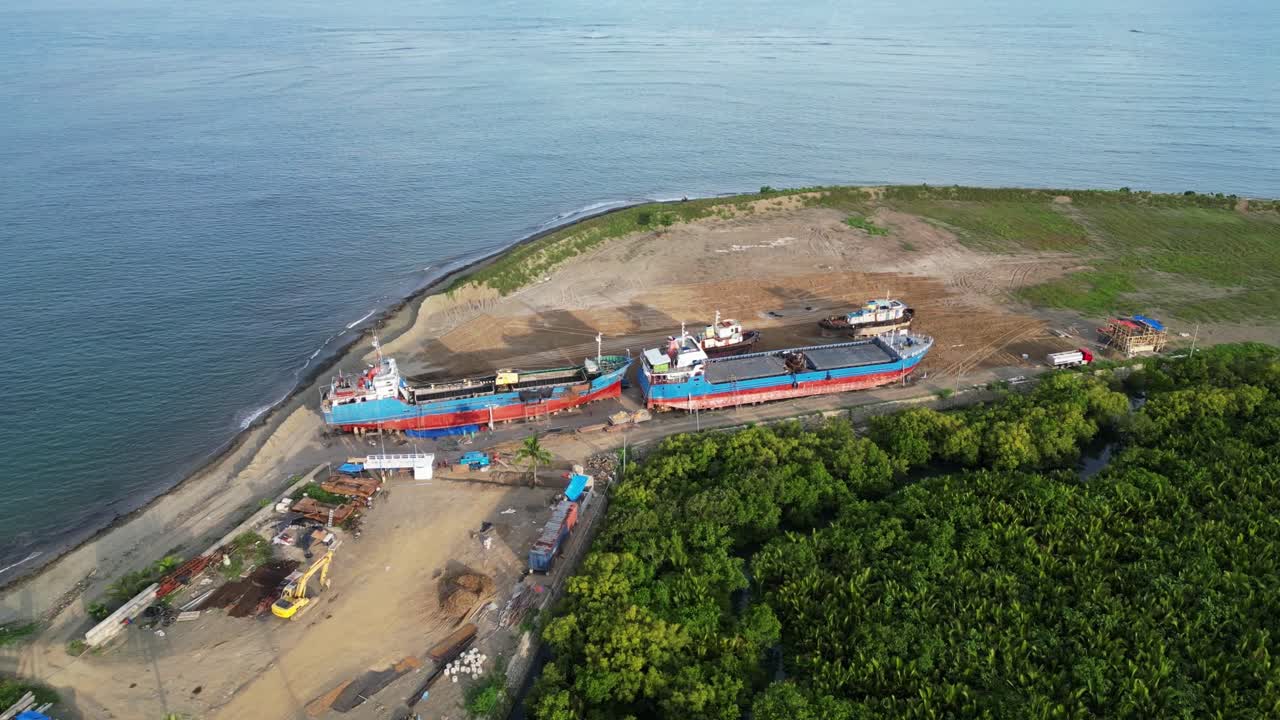 필리핀 카탄두아네스 의 건설 현장 근처 의 모래 해변 에 혀 있는 두 척 의 화물 선박