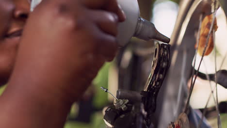 woman greasing rusty bicycle chain