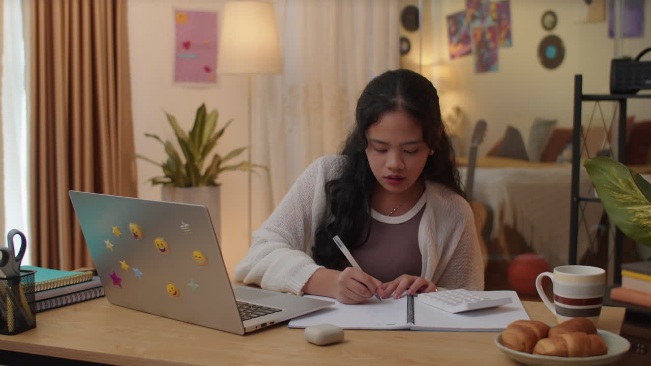 Asian Girl Giving Answer during Online Seminar Using Laptop from Home