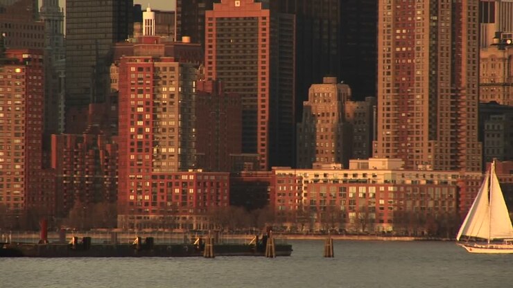 A Sailboat Heads Toward The Pier Off Downtown Manhattan