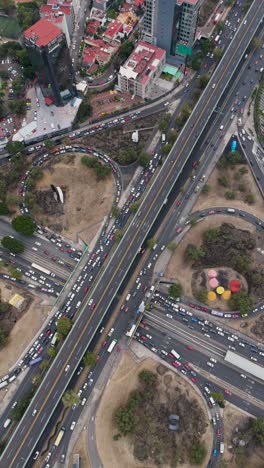 vertical drone shot of a cloverleaf intersection in cdmx