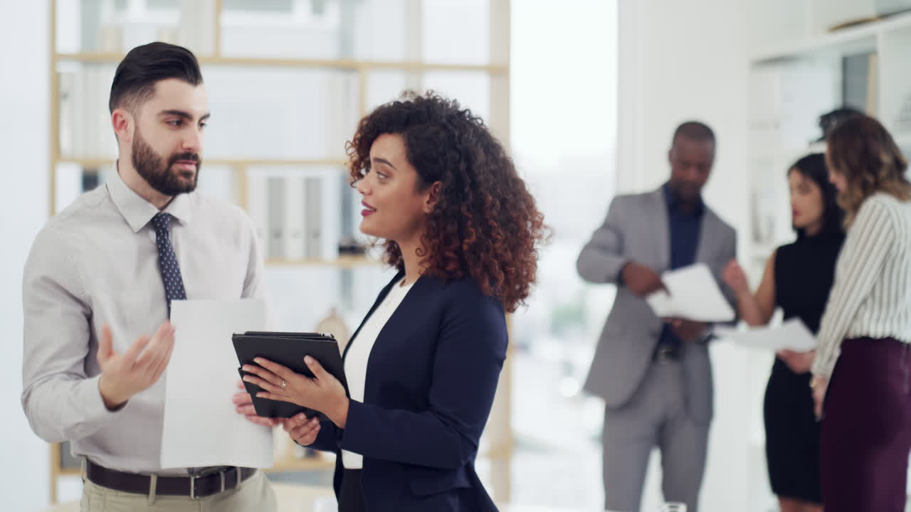 two businesspeople working together on a digital