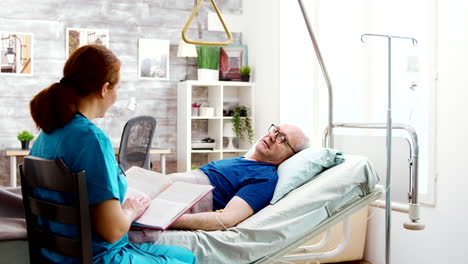 old retired sick man lying in hospital bed in a nursing home