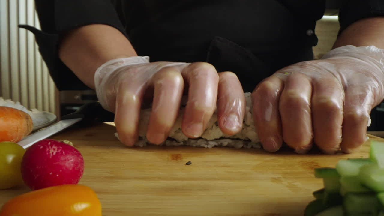 Close-up of Chef Making Sushi Rolls with Fresh Vegetables