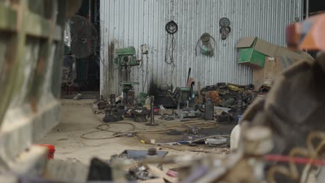 busy workshop with various machinery and parts