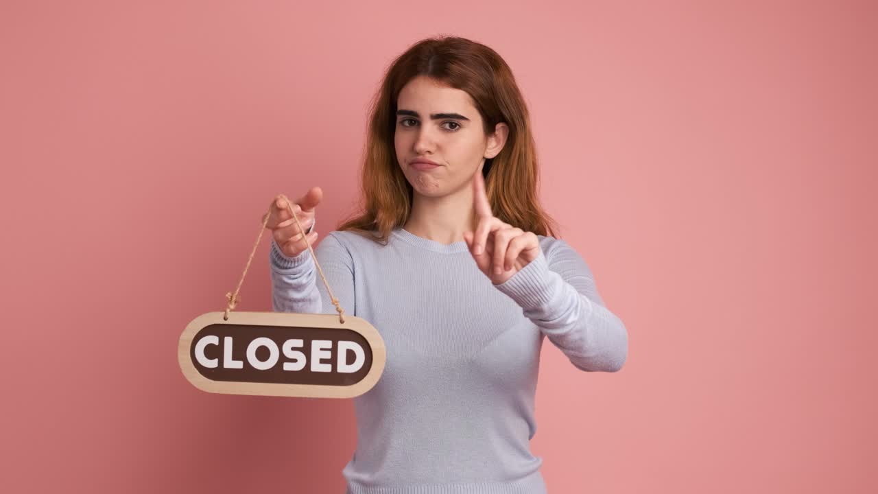 Woman closing an area by putting up a sign