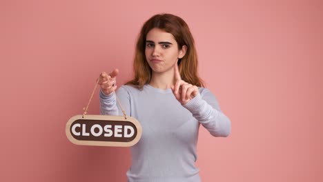 woman closing an area by putting up a sign