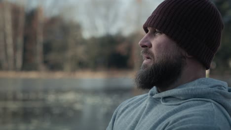 adult caucasian man breathing deeply being outdoors in the winter.