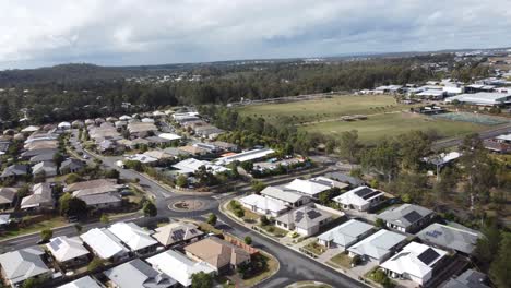 Aerial-view-of-a-residential-estate-revealing-private-homes,-streets-and-roundabouts