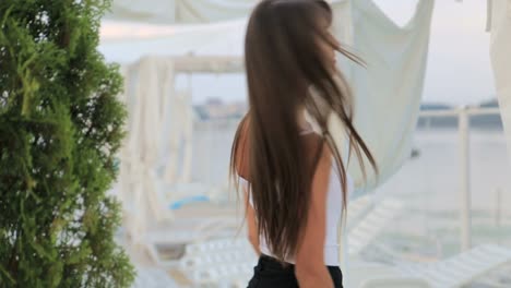 of a beautiful caucasian brunette in front of a mirror in a beauty salon of a beautiful caucasian brunette in front of a mirror in a beauty salon she looks at herself enjoying her smooth velvety skin and her beauty