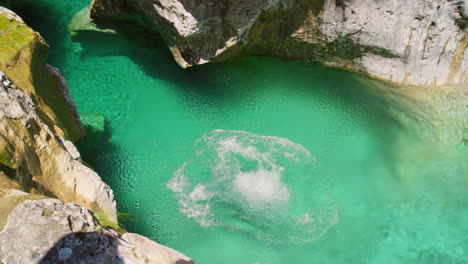 Carefree-woman-jumping-into-a-lake-swimming