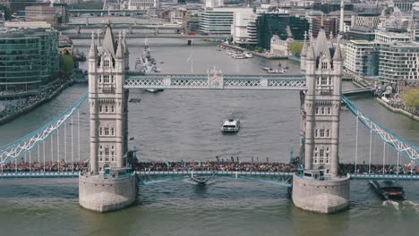 Aerial-Approaching-Pan-Down-of-London-Marathon-Runners-on-Tower-Bridge