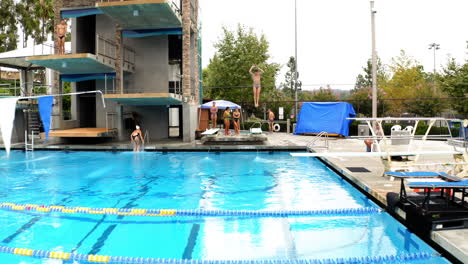 a sequence of a high diver in action at an outdoor swimming pool
