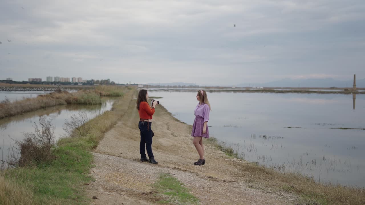 Photographer taking pictures of a model by a lake