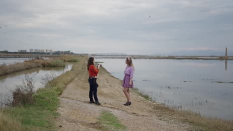 photographer taking pictures of a model by a lake