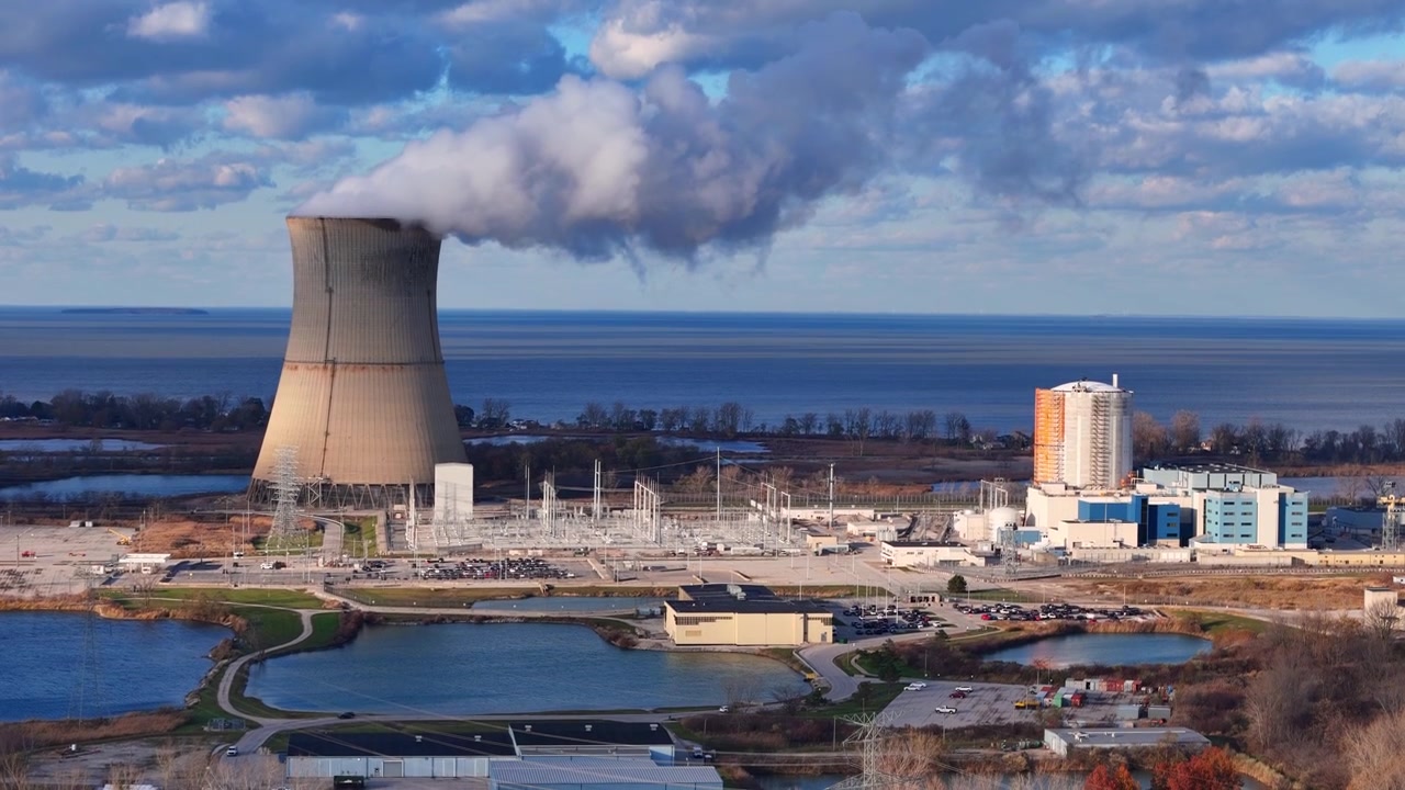 Kerncentrale Davis-Besse stoot stoom uit via de koeltoren aan de oever van het Eriemeer, VS.
