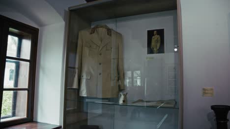 military uniform of josip broz tito displayed in a glass case in kumrovec museum, croatia