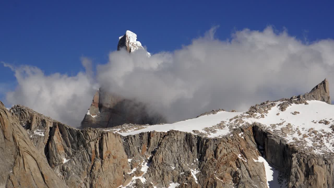 Time-lapse of Clouds Surrounding Cerro Torre in Patagonia under a blue sky. Los Glaciares National Park. Argentina