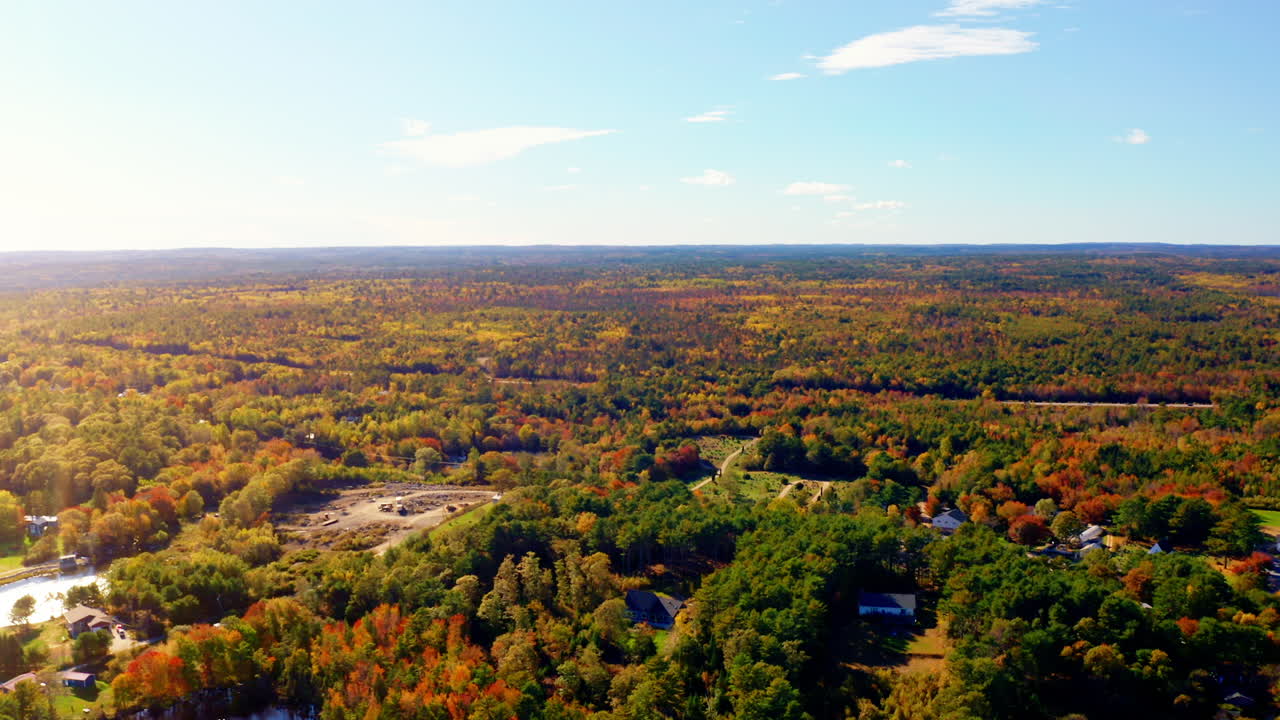 Aerial drone shot over the vast landscape of Nova Scotia, Canada. High view of the vast forest. Autumn colorful foliage. Picturesque scenic landscape.