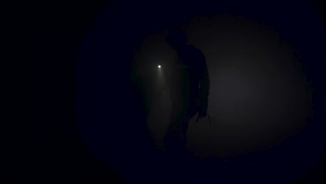 silhouette of a person in a dark foggy environment