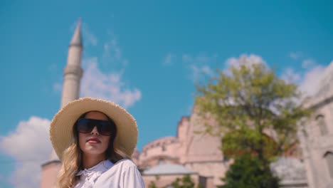 slow motion:beautiful young girl poses in front of an ancient building in istanbul,turkey,travel concept