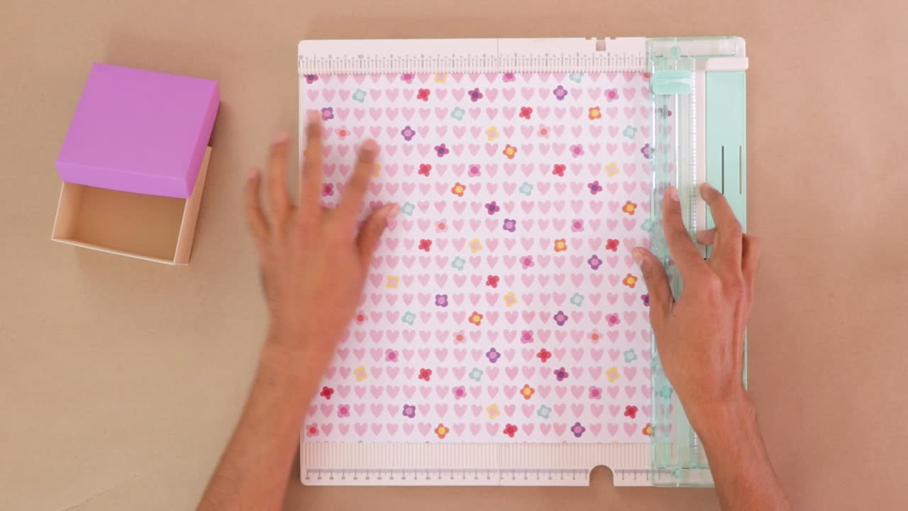 Cutting lovely decorated paper with trim and score board for wrapping