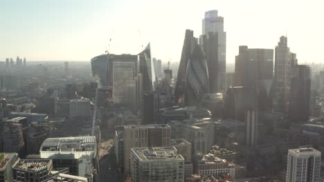 Circling-aerial-shot-of-dense-central-London-skyscrapers-from-Aldgate