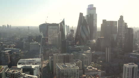 tomada aérea circular de los densos rascacielos del centro de londres desde aldgate