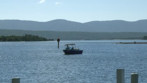 two local fisherman drifting in boat, floating in body of water
