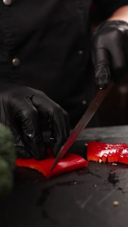 chef slicing red bell pepper