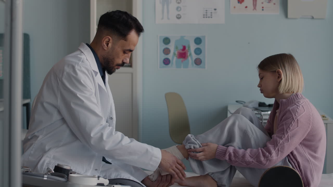 Doctor examining patient's ankle