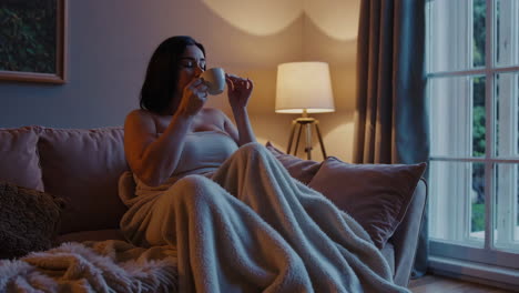 woman relaxing on sofa with coffee