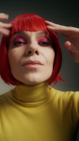 woman with red wig and yellow sweater