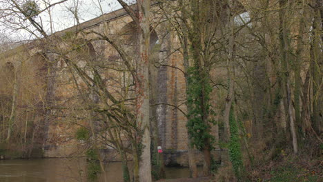 Pan-shot-of-the-Clécy-historic-viaduct,-former-railway-in-the-city-of-Clécy,-France