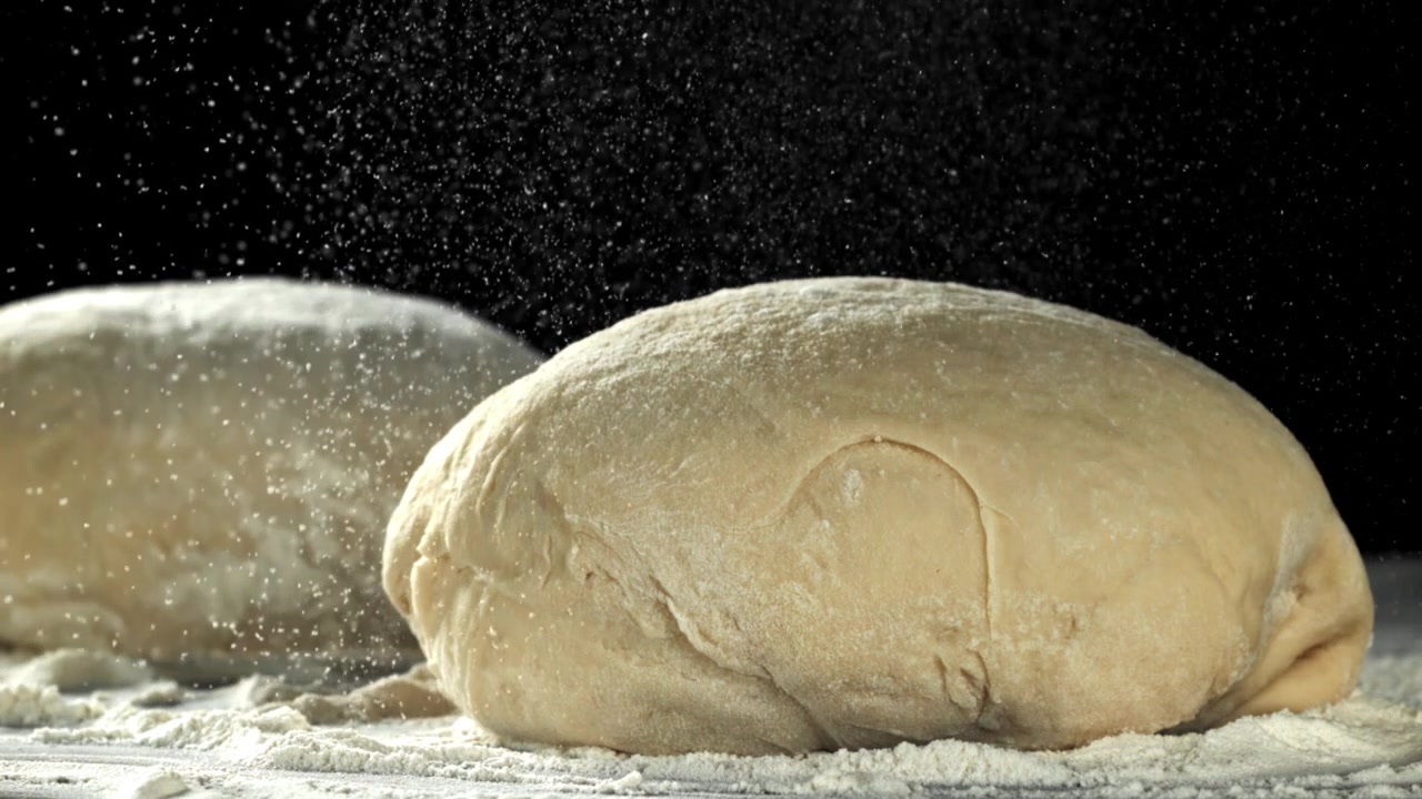Slow Motion of Flour Falling on Raw Dough