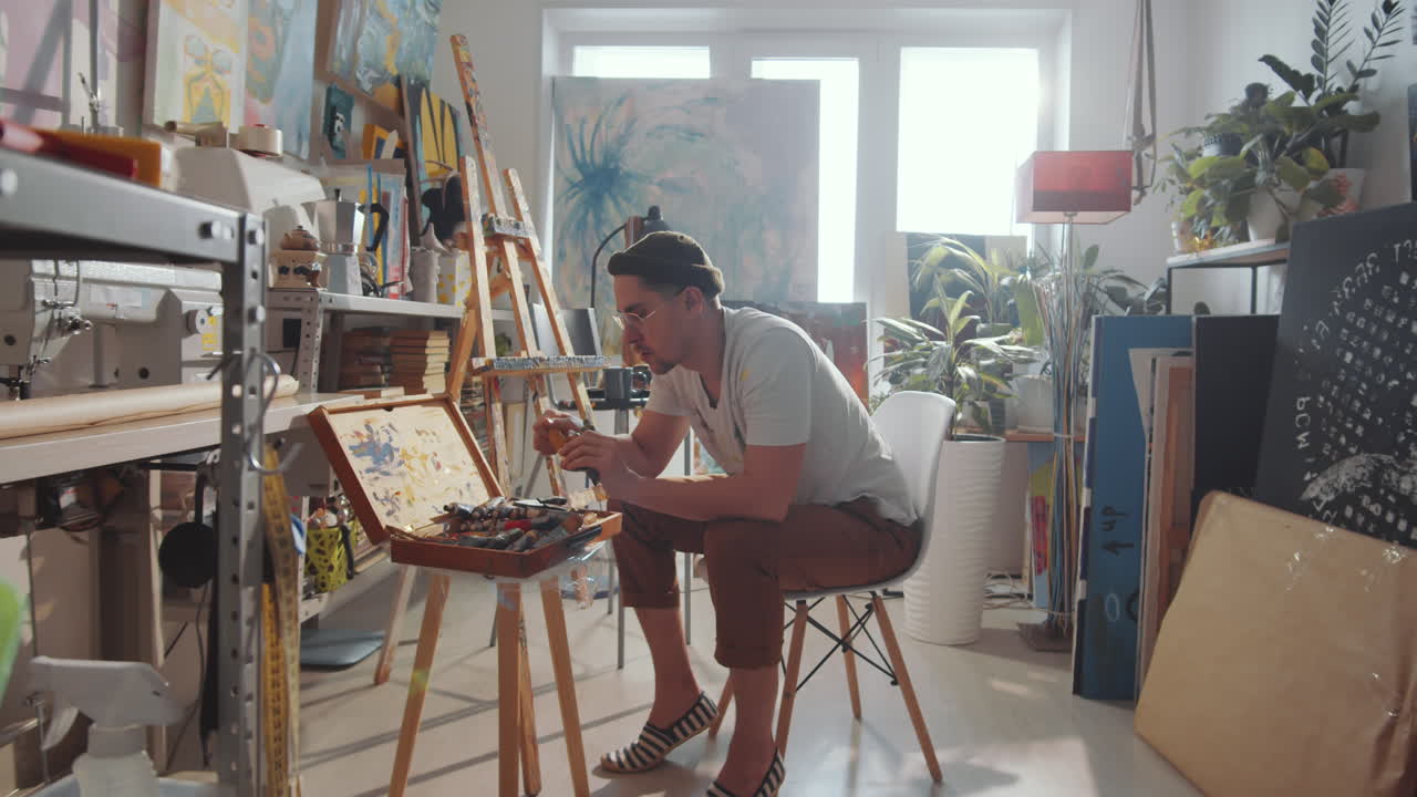 Male Artist Preparing Tools in Creative Studio