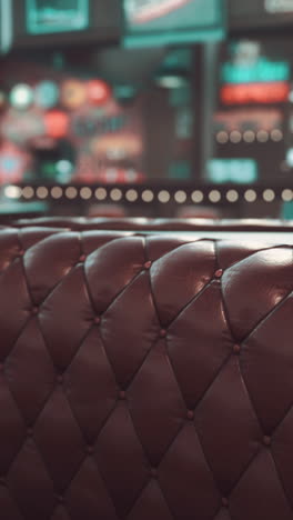 close up of a brown tufted leather booth in a restaurant