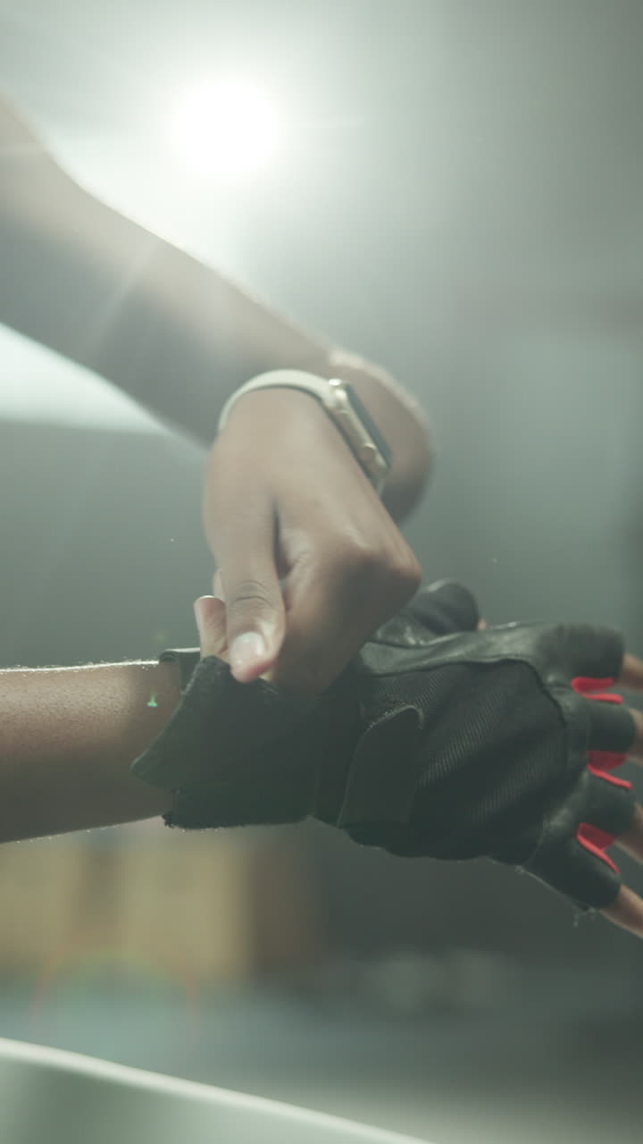 Close-up of Person Putting on Gym Glove for Workout