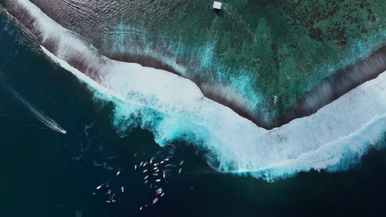 Surfing waves crashing on shallow reef Teahupoo Tahiti aerial drone birds eye view French Polynesia boats jetski surfer 2024 surf judge tower Pacific Ocean Channel Point Faremahora Pass Havae static