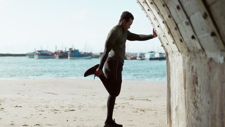 Beach, exercise and black man stretching
