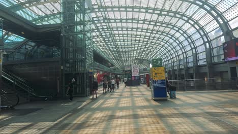 travelers navigate through turin's modern train station