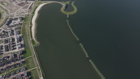 Reveal-shot-of-tulpeiland-near-Zeewolde-flevoland-during-daytime,-aerial