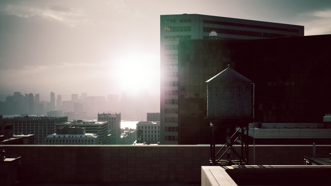 Sunset reflections from a rooftop overlooking a city skyline