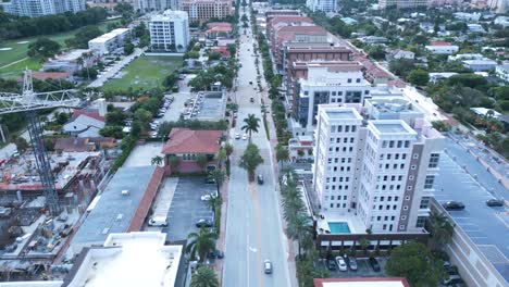 aerial view of road traffic and construction site in boca raton city, florida usa, dolly drone shot