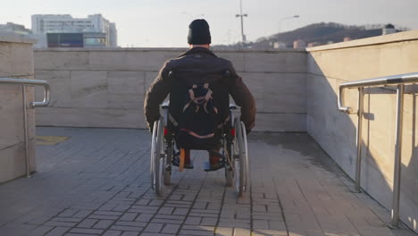 person in wheelchair on city ramp