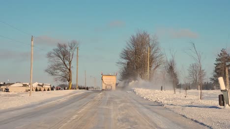 driving on the street following a truck removing snow along the way in brampton, ontario at winter