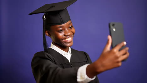 happy graduate taking a selfie with a smartphone