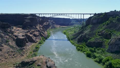 a 4k fly-over drone shot of perrine bridge, a 1,500 foot long bridge, spanning over the snake river in twin falls, idaho